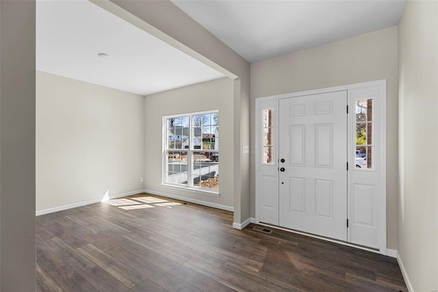 entryway with dark hardwood / wood-style flooring