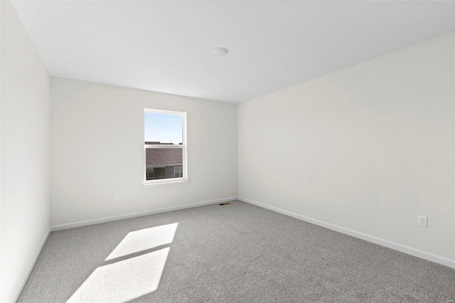 unfurnished room featuring carpet floors