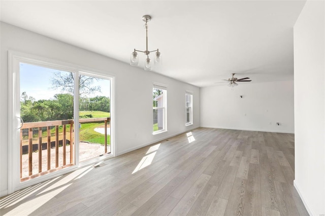 unfurnished living room featuring ceiling fan and light wood-type flooring