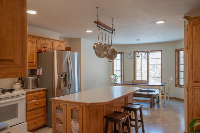 kitchen featuring white electric range oven, tasteful backsplash, decorative light fixtures, a center island, and stainless steel fridge with ice dispenser