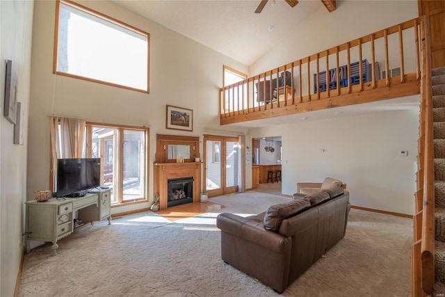 carpeted living room with high vaulted ceiling and ceiling fan