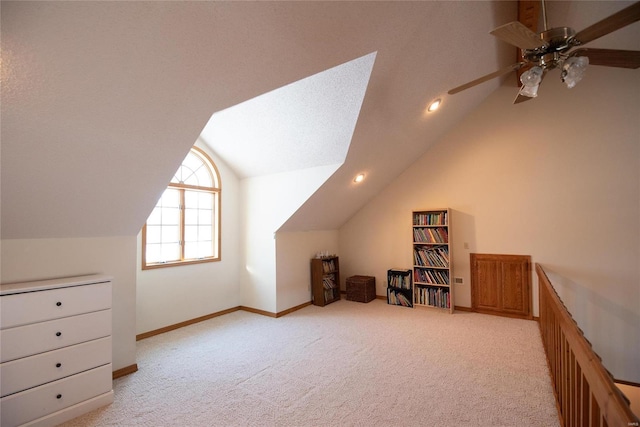 additional living space featuring ceiling fan, lofted ceiling, light carpet, and a textured ceiling