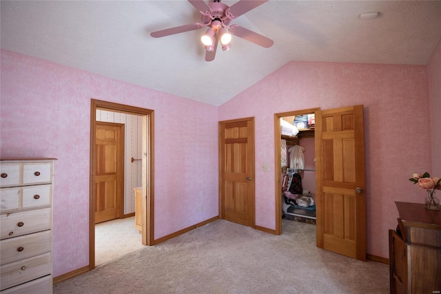 bedroom with light colored carpet, a spacious closet, vaulted ceiling, and a closet