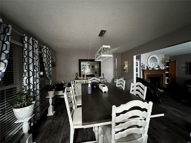 dining space featuring dark hardwood / wood-style floors and a textured ceiling