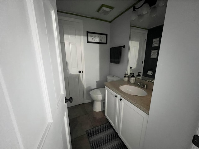 bathroom with vanity, tile patterned floors, and toilet