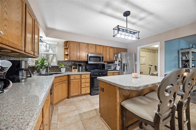 kitchen featuring pendant lighting, appliances with stainless steel finishes, a center island, a kitchen bar, and decorative backsplash