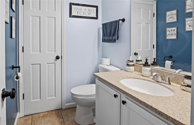 bathroom with vanity, toilet, and tile patterned flooring