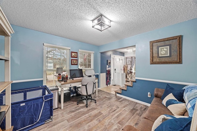 office space with light hardwood / wood-style flooring and a textured ceiling