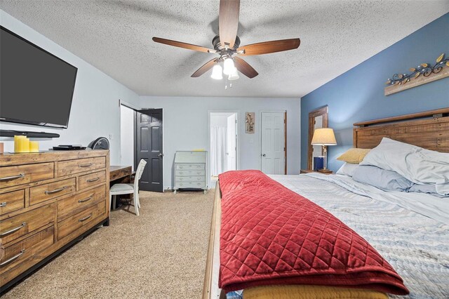 bedroom with ceiling fan, a textured ceiling, and carpet