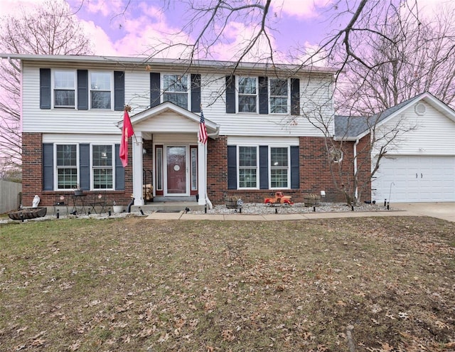 view of front of property with a garage and a yard