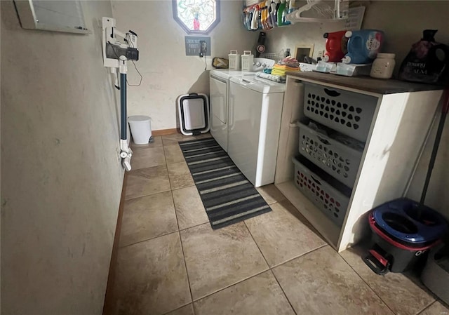 clothes washing area featuring washer and dryer and light tile patterned floors