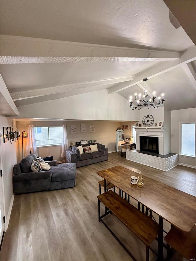 living room with wood-type flooring, vaulted ceiling with beams, and a chandelier