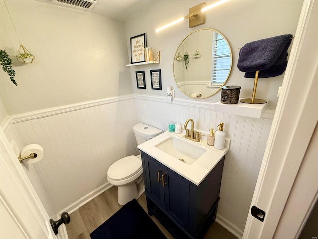 bathroom with vanity, wood-type flooring, and toilet