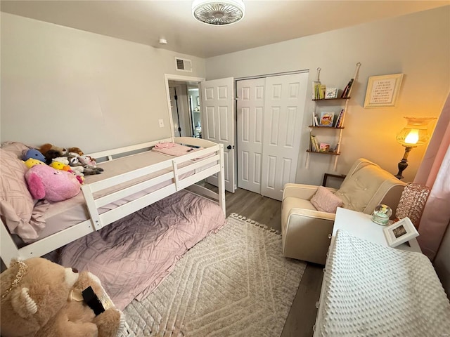 bedroom with hardwood / wood-style floors and a closet