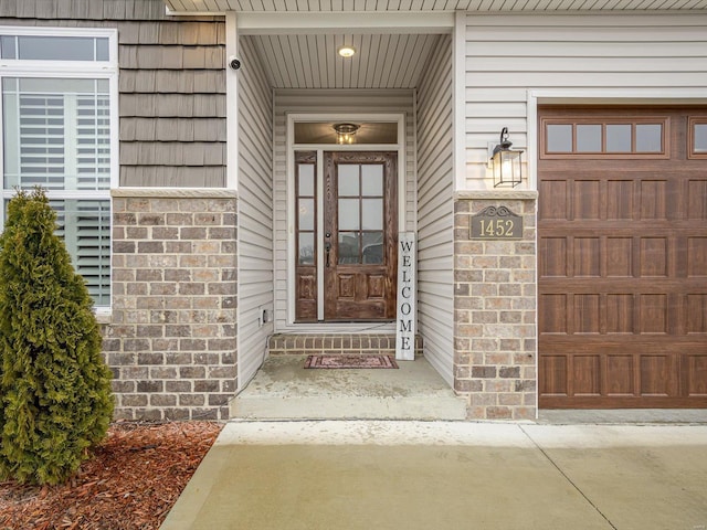 entrance to property featuring brick siding