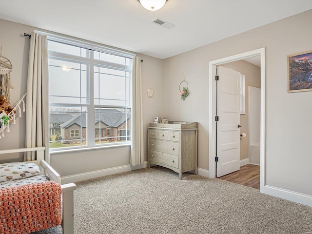 carpeted bedroom featuring multiple windows, visible vents, and baseboards