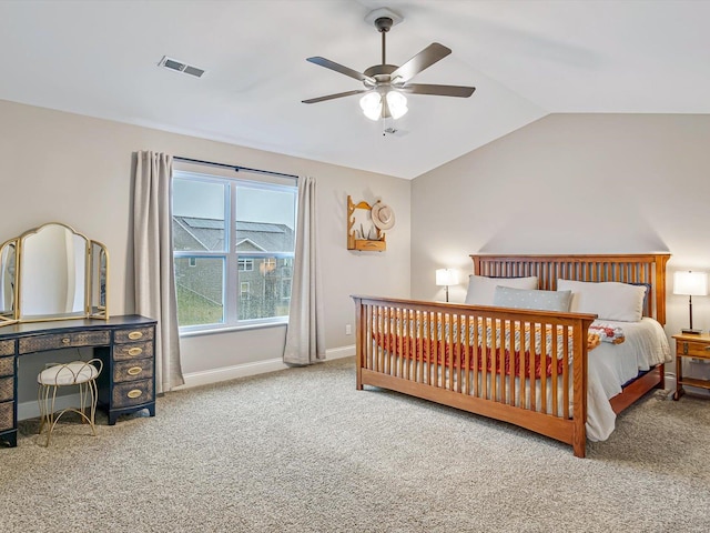 carpeted bedroom with lofted ceiling, a ceiling fan, visible vents, and baseboards