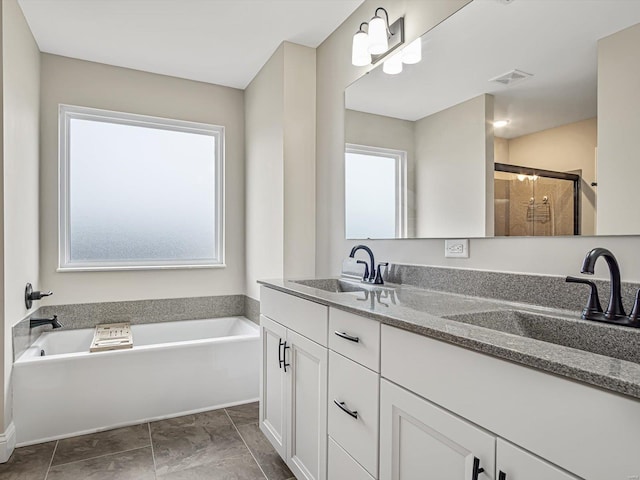 full bathroom with a garden tub, a stall shower, a sink, and visible vents