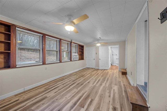 unfurnished room featuring cooling unit, ceiling fan, and light hardwood / wood-style flooring