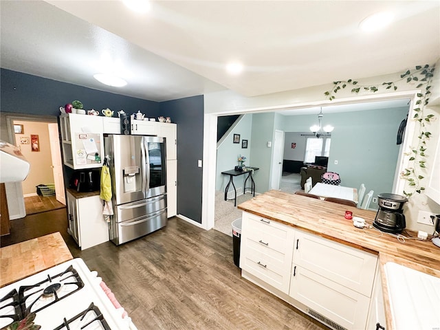 kitchen featuring dark hardwood / wood-style floors, pendant lighting, butcher block counters, white cabinets, and stainless steel fridge with ice dispenser