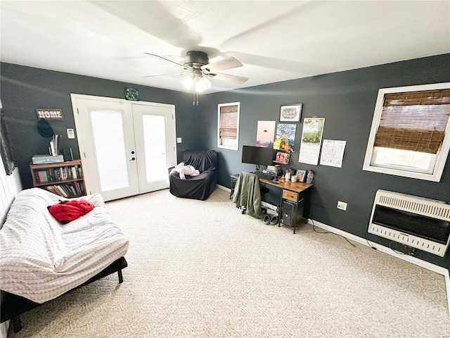 sitting room featuring heating unit, french doors, ceiling fan, and carpet flooring