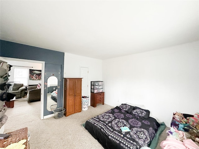 bedroom featuring light colored carpet