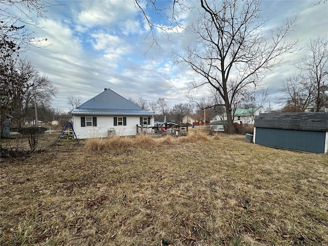 view of yard with a playground and a storage shed