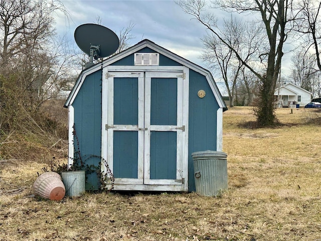 view of outdoor structure featuring a lawn