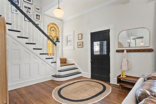 entryway featuring dark wood-type flooring and ornamental molding