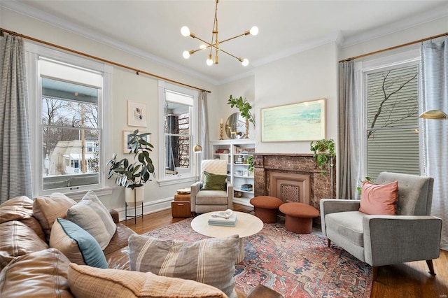 sitting room featuring an inviting chandelier, crown molding, a high end fireplace, and hardwood / wood-style floors