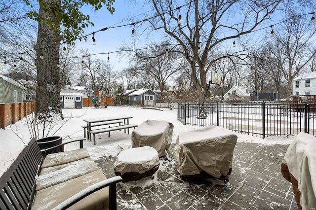 snow covered patio featuring an outbuilding