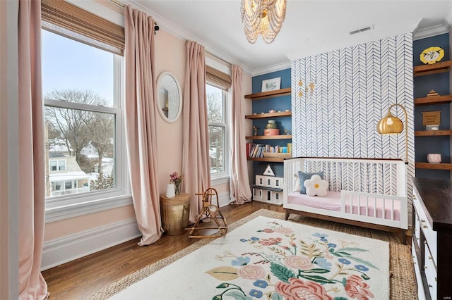 sitting room featuring hardwood / wood-style floors and ornamental molding