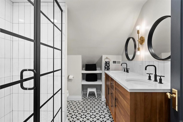 bathroom with toilet, backsplash, and vanity