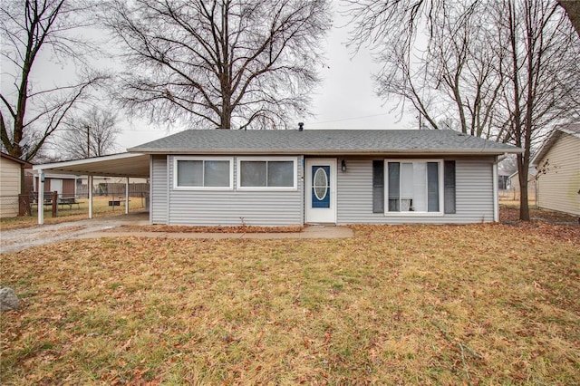 ranch-style house featuring a carport and a front lawn