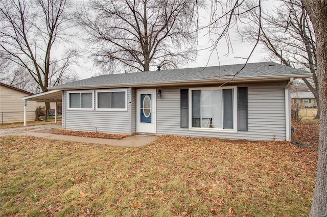 ranch-style house with a carport and a front yard