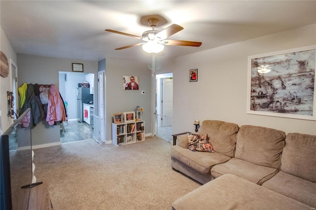 carpeted living room with ceiling fan