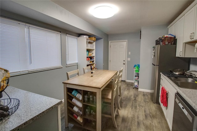 kitchen with dark hardwood / wood-style flooring, white cabinets, sink, and black dishwasher