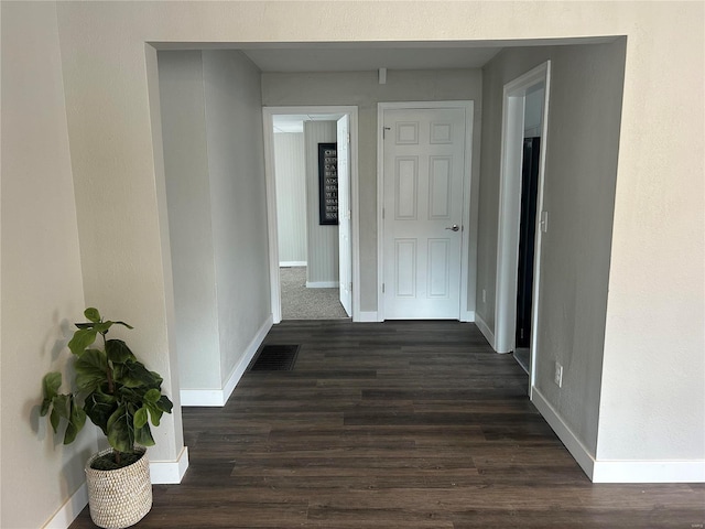 corridor featuring dark wood-type flooring