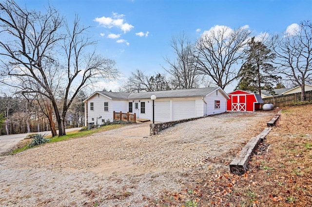 view of front of home featuring a garage and a storage shed