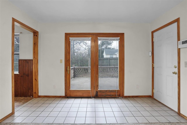 doorway to outside with light tile patterned floors