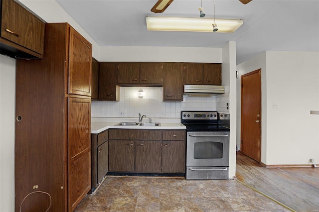 kitchen with stainless steel electric range oven, dark brown cabinets, sink, and backsplash