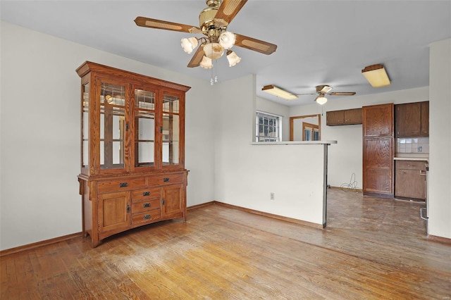 unfurnished dining area featuring hardwood / wood-style flooring and ceiling fan