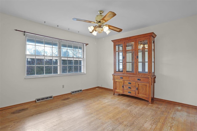 unfurnished room with ceiling fan and light hardwood / wood-style flooring