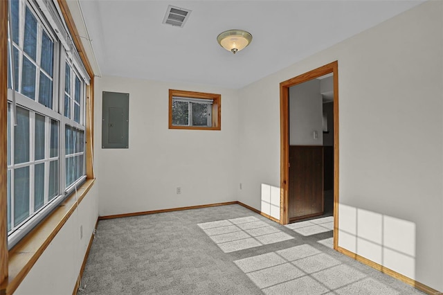 carpeted spare room featuring electric panel