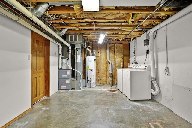 basement featuring washing machine and dryer and water heater