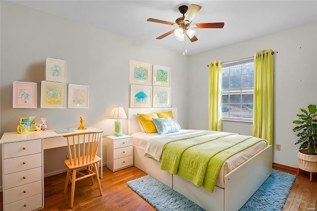 bedroom with light hardwood / wood-style flooring and ceiling fan