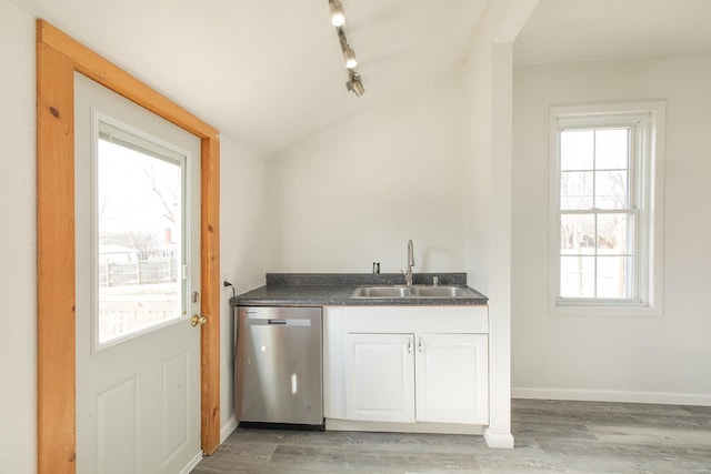 interior space featuring dishwasher, lofted ceiling, sink, white cabinets, and light wood-type flooring