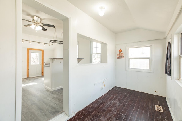 empty room with wood-type flooring, lofted ceiling, and ceiling fan