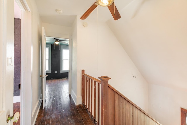 hallway featuring lofted ceiling and dark wood-type flooring