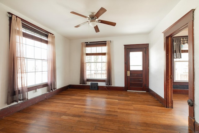 foyer entrance with dark hardwood / wood-style floors and ceiling fan